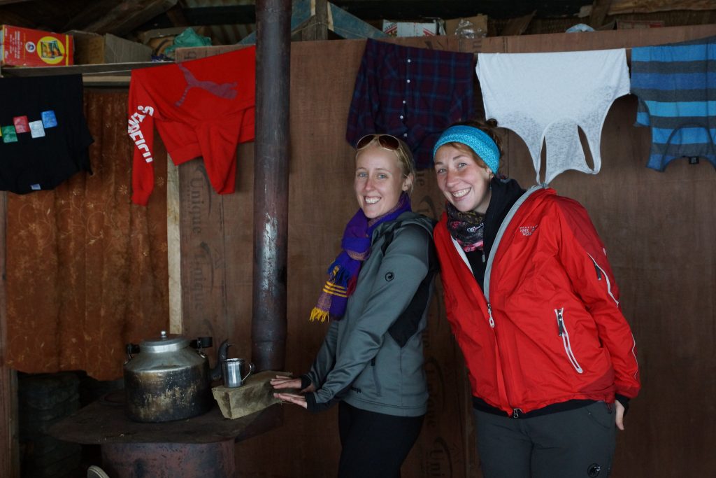 Warming up next to the fire with milk tea at High Camp on Mardi Himal Trek in Nepal